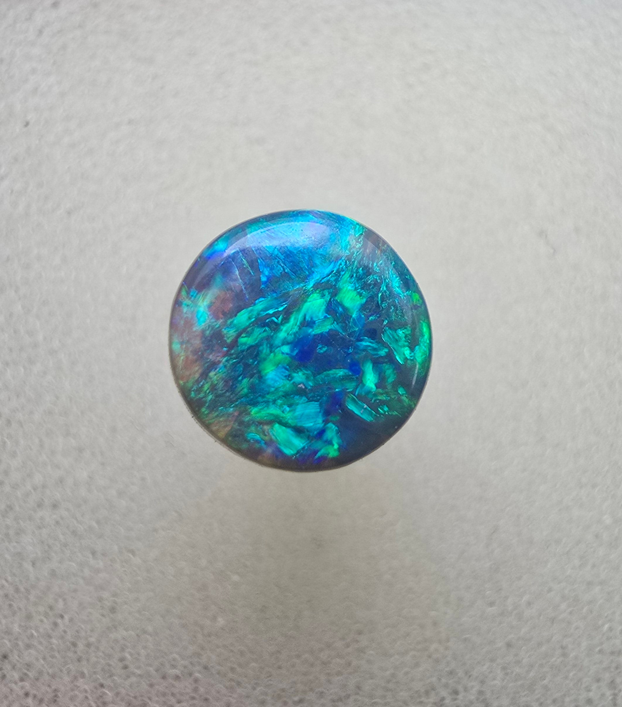 A666 - Bright round cut black opal