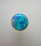 A666 - Bright round cut black opal