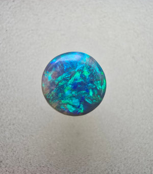 A666 - Bright round cut black opal