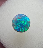 A666 - Bright round cut black opal