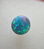 A666 - Bright round cut black opal