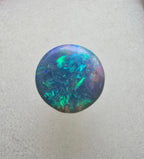 A666 - Bright round cut black opal