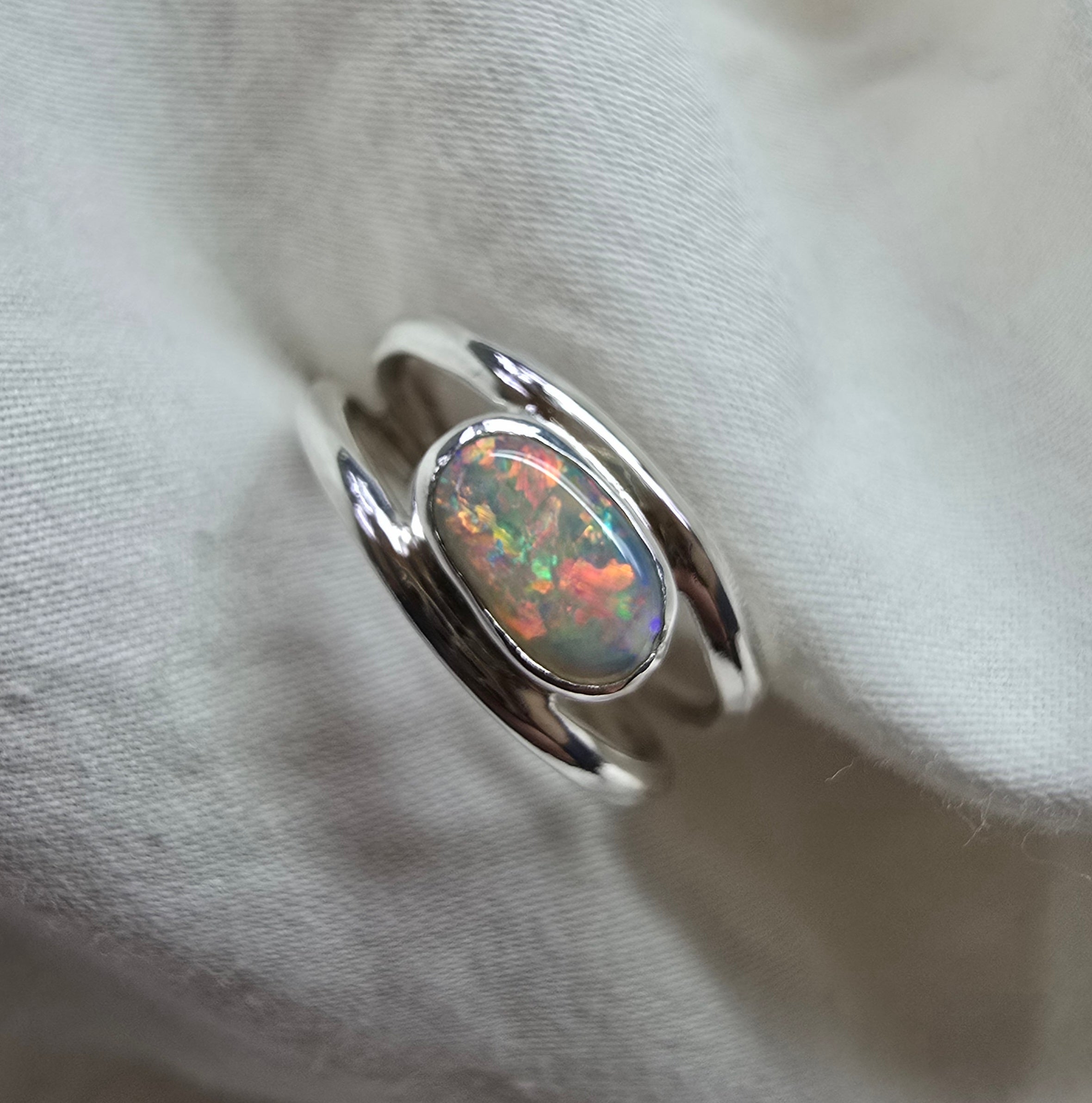 J011 - Bright multicoloured dark opal ring