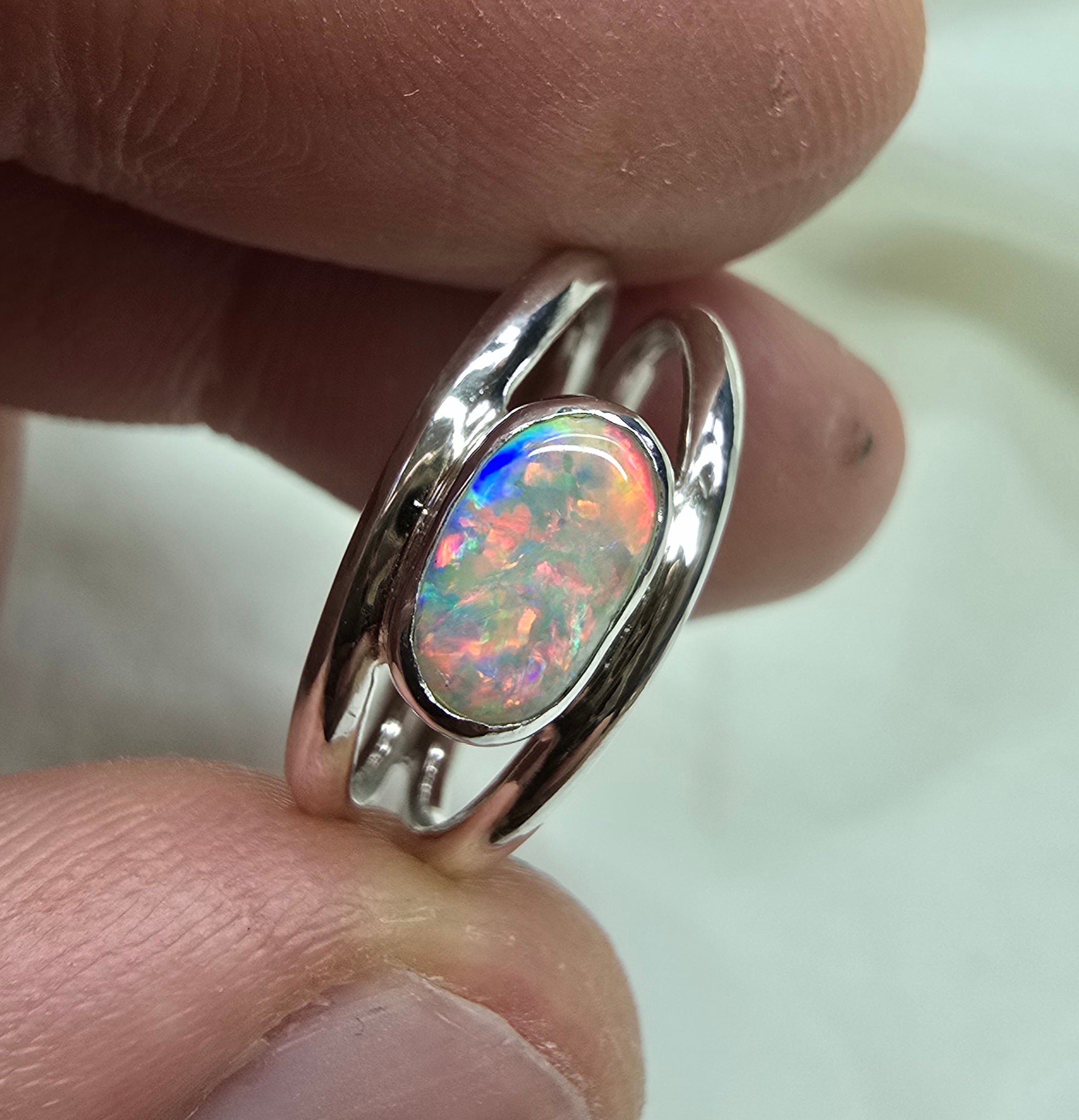 J011 - Bright multicoloured dark opal ring