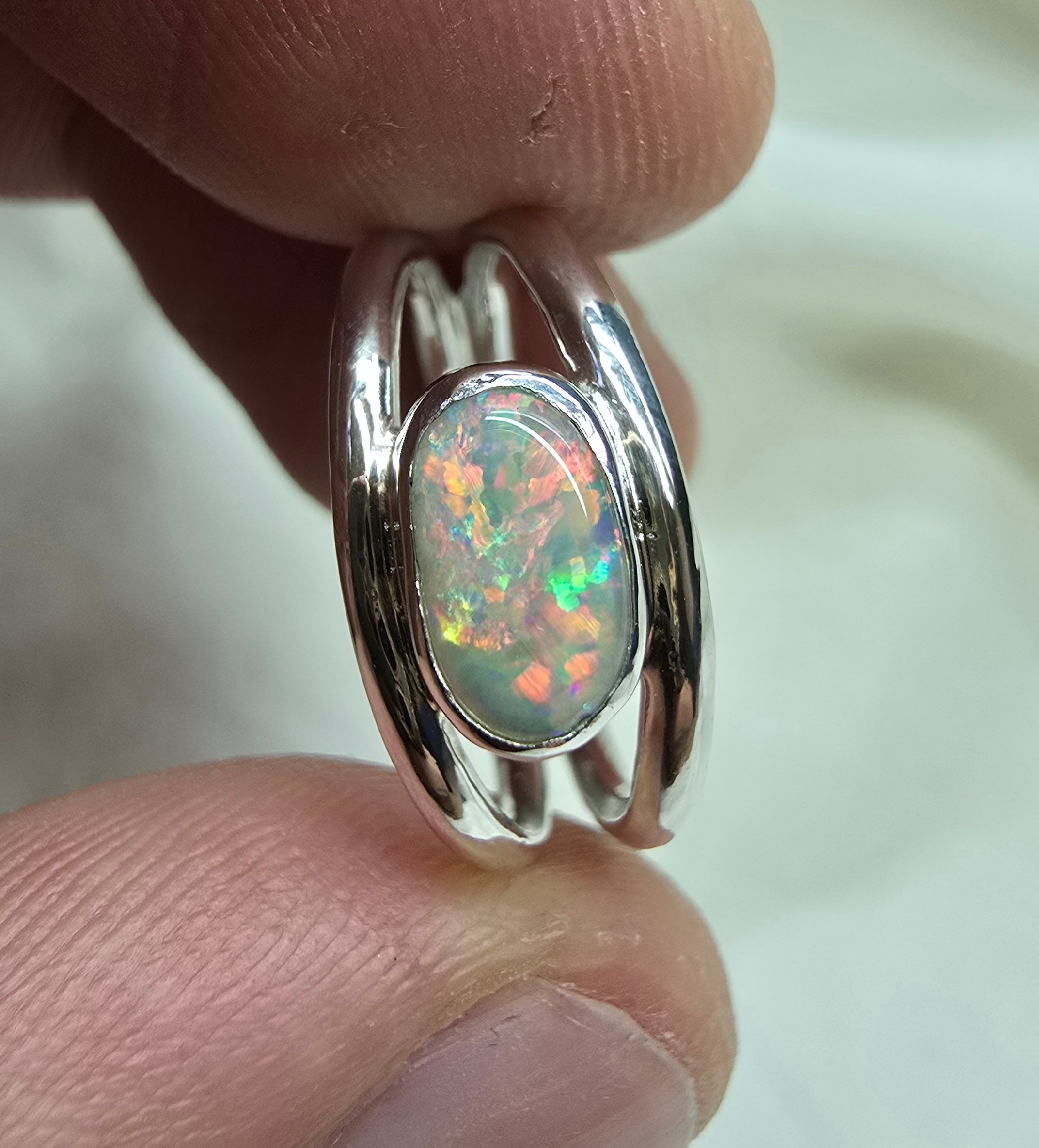 J011 - Bright multicoloured dark opal ring
