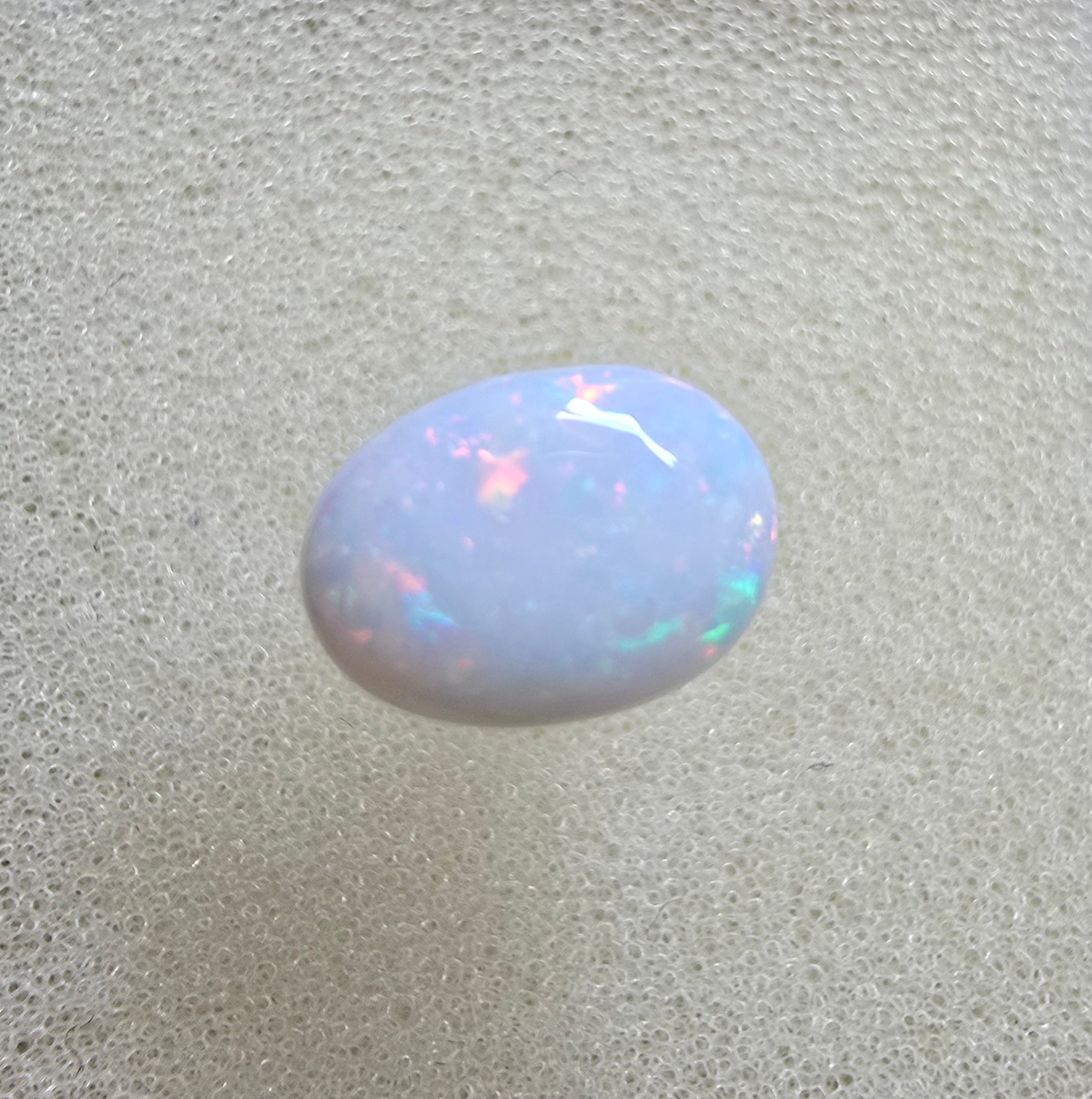 A889 - Pearl white round cut opal