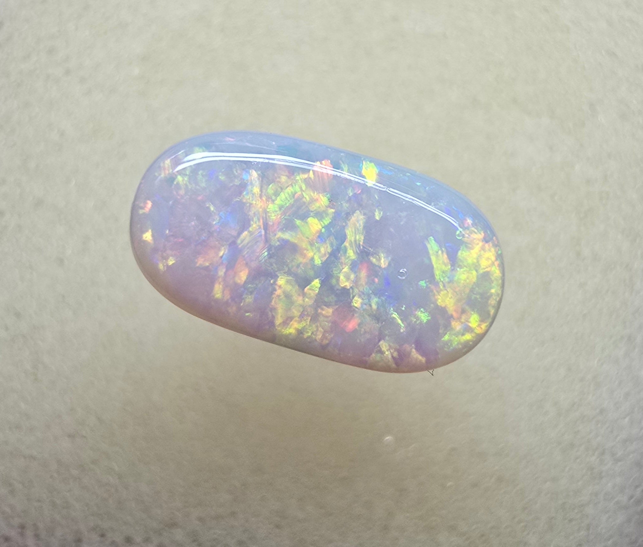A911 - Oval cut bright red fire white opal