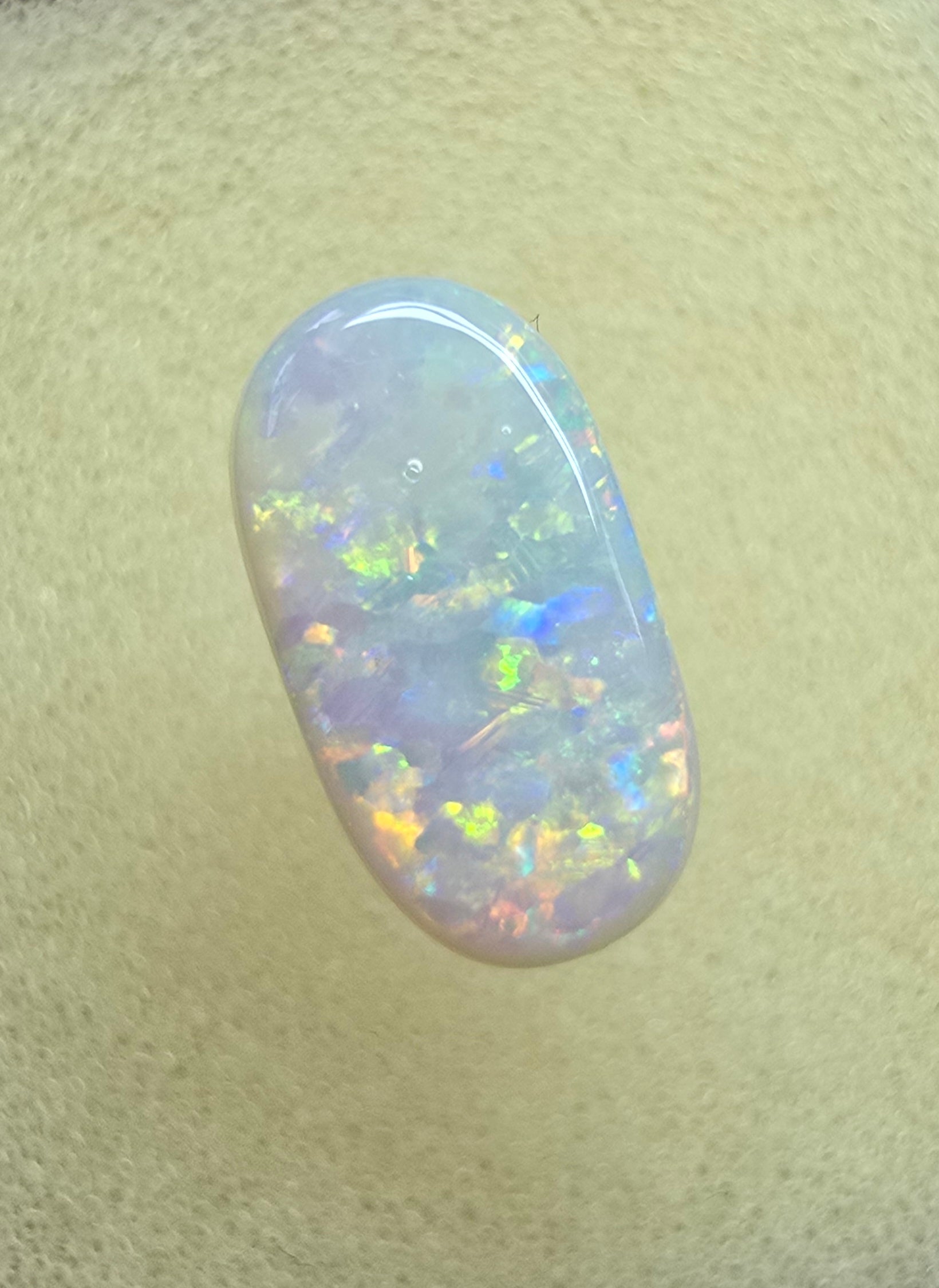 A911 - Oval cut bright red fire white opal