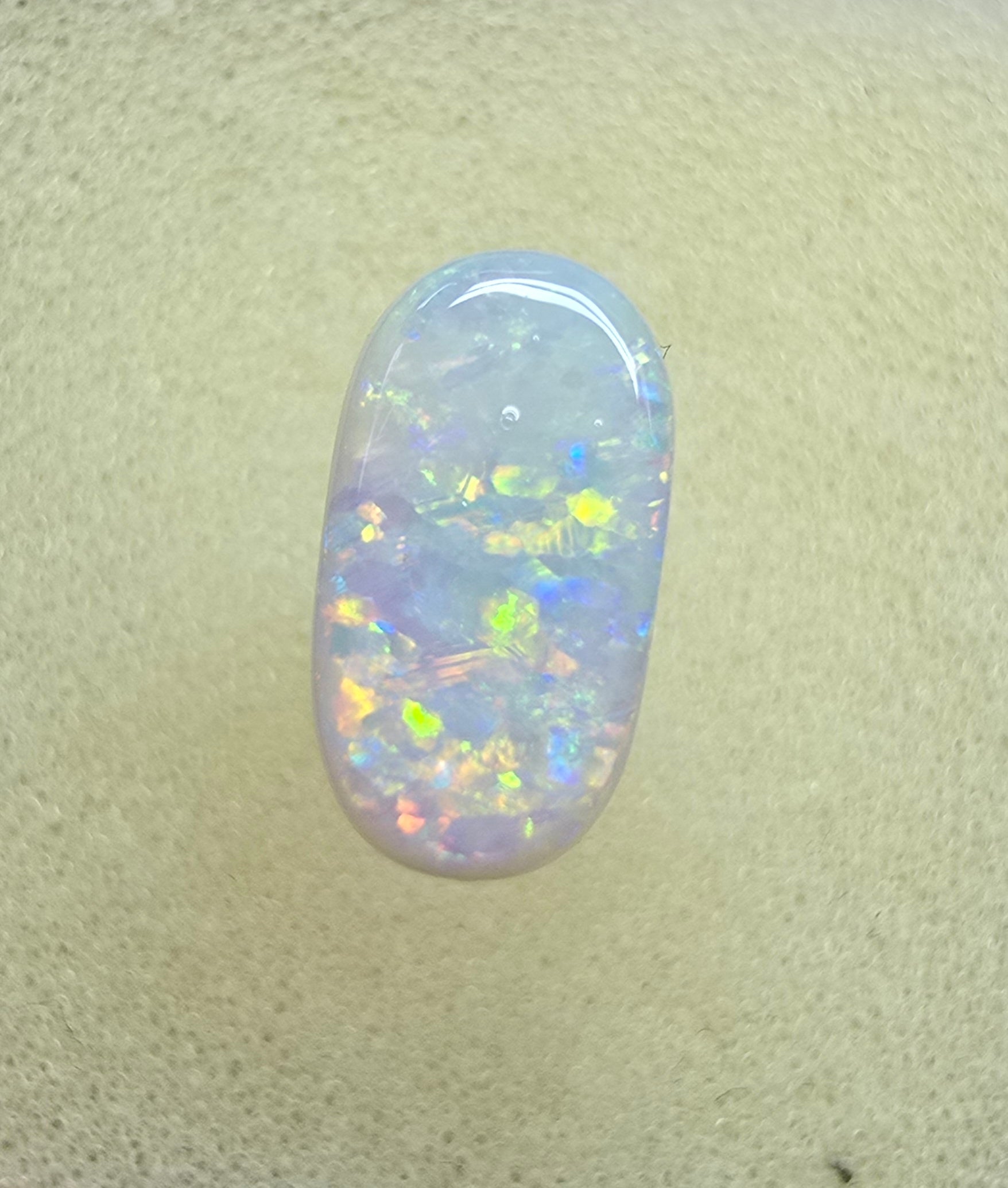A911 - Oval cut bright red fire white opal
