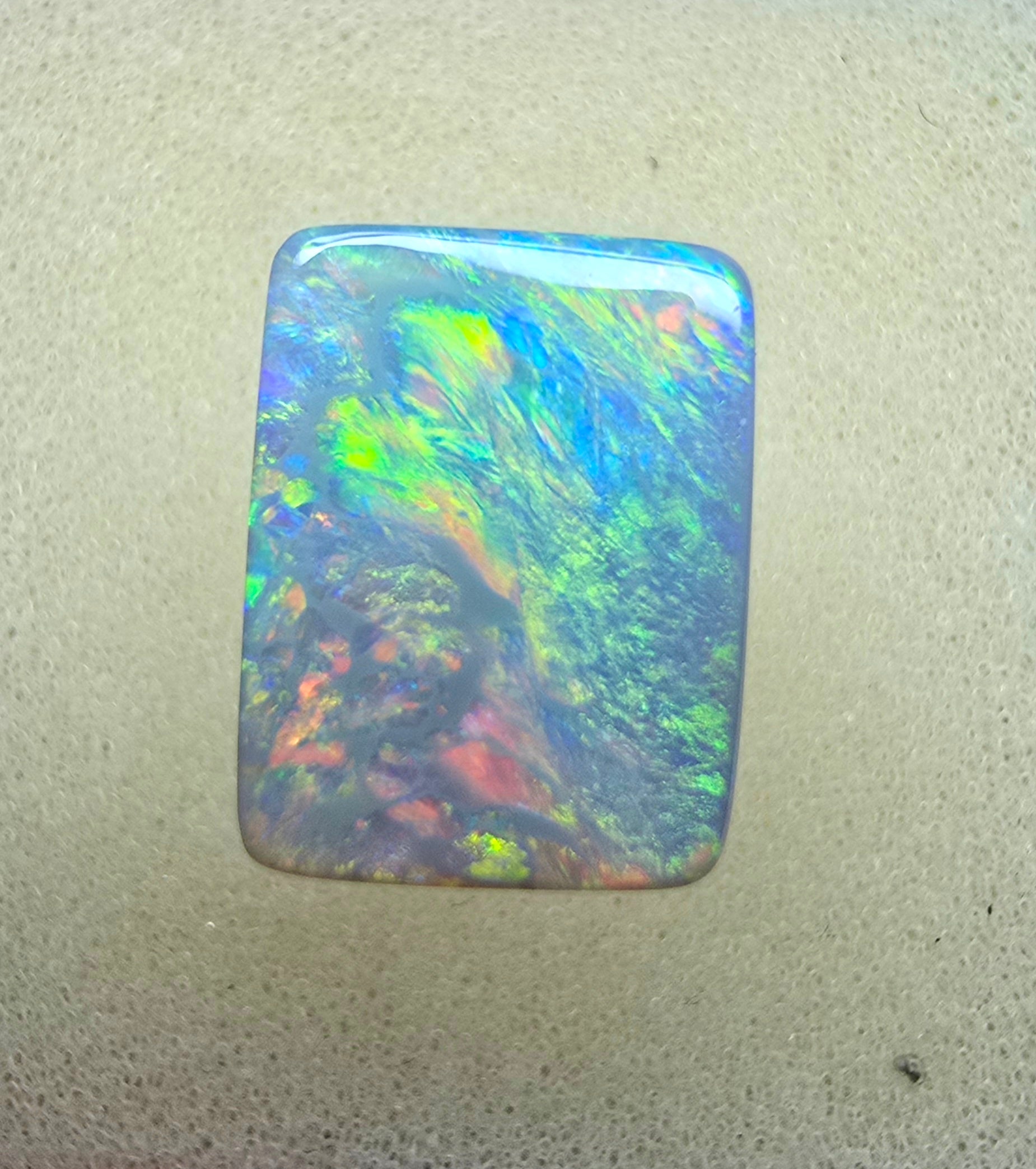 A940 - Stunning broad face cushion cut dark opal.