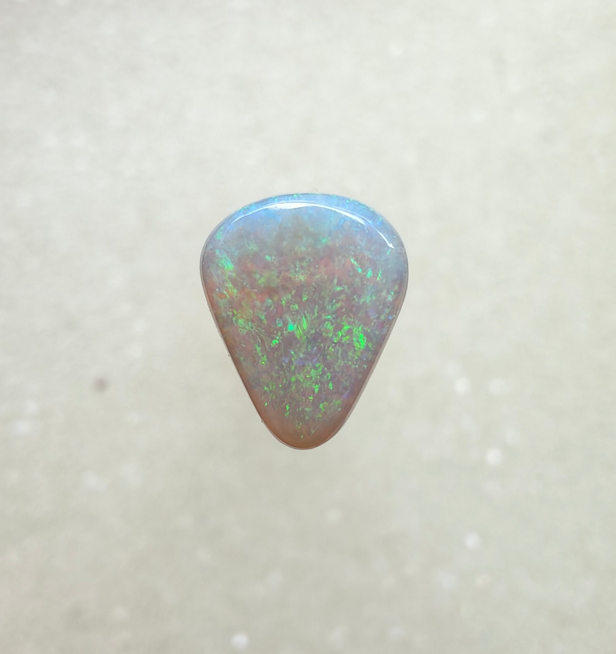 A960 - Sparkly green drop cut white opal