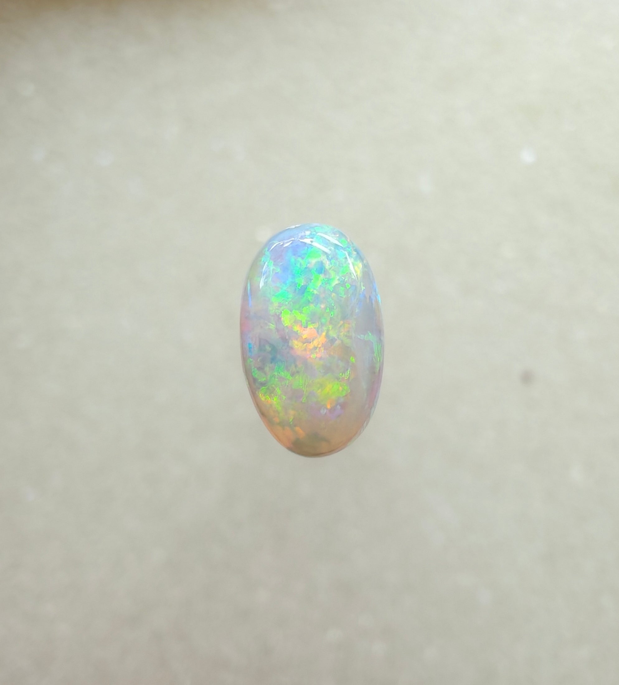 A963 - Bright round cut crystal opal.