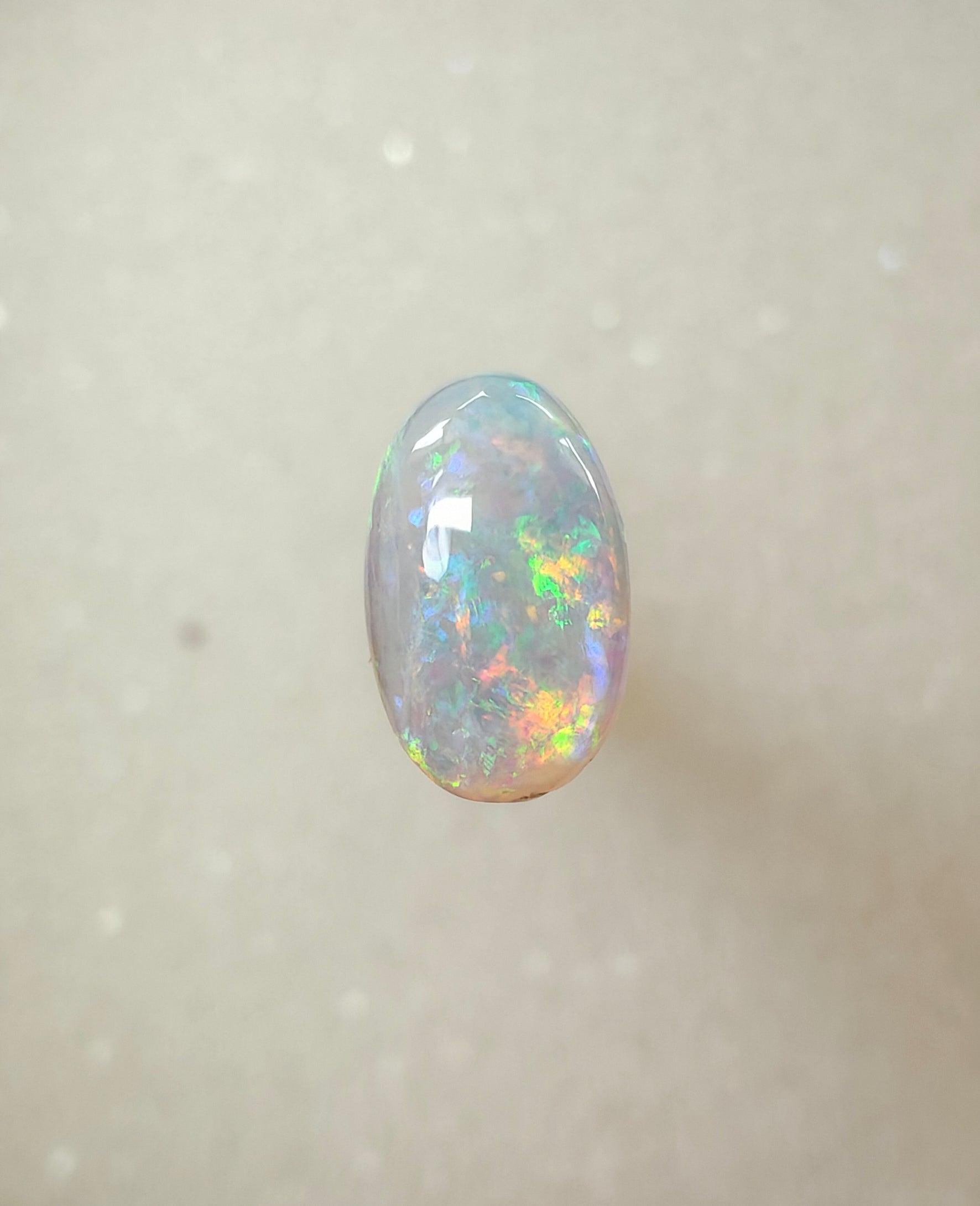 A963 - Bright round cut crystal opal.