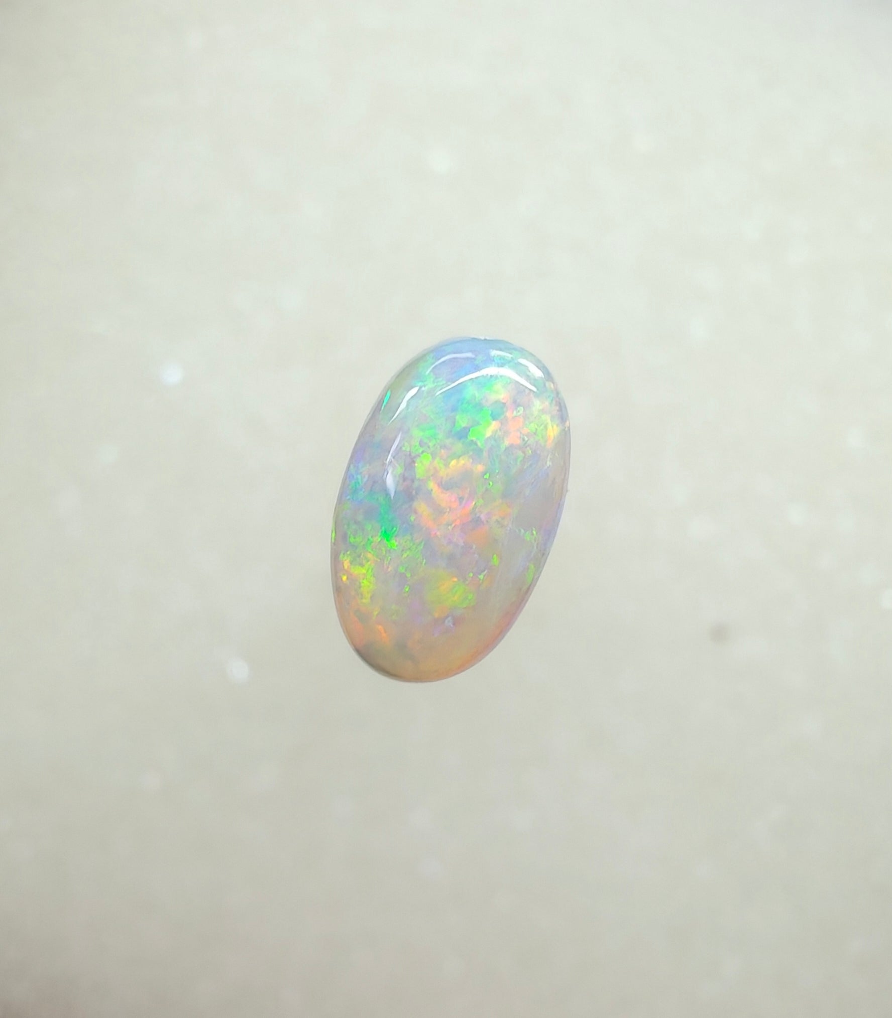 A963 - Bright round cut crystal opal.