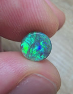 A666 - Bright round cut black opal