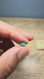 A945 - Bright black opal round cut